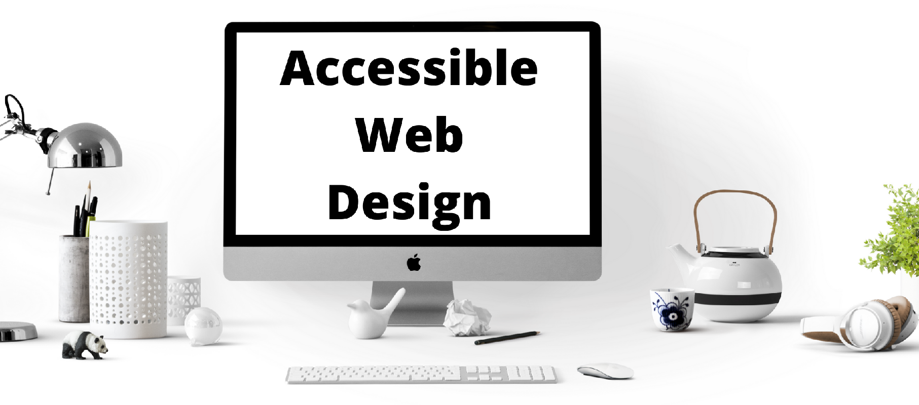 White desktop monitor with black text on the screen that says "Accessible Wed Design"